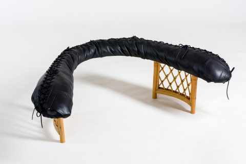 Sarah  Contos Fireplace, 2019; repurposed cane and leather, poly-fibre; 42 x 125 x 95 cm; enquire