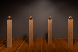 installation view; Julie Rrap Brazen Heads, 2026; bronze, wood; 12 parts; 161 x 24 x 24 cm each, dimensions variable based on installation configuration; Edition of 2 + 1 AP; enquire