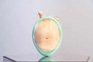 Patricia Piccinini Egg Head in Motion, 2025; silicone, polyurethane, hair, stainless steel, microcontroller, motor, mirrored plinth; 95 x 50 x 61 cm; From a suite of 3 colour variations; enquire
