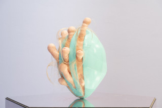 Patricia Piccinini Egg Head in Motion, 2025; silicone, polyurethane, hair, stainless steel, microcontroller, motor, mirrored plinth; 95 x 50 x 61 cm; From a suite of 3 colour variations; enquire