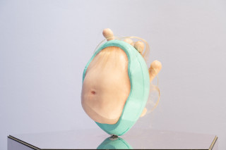 Patricia Piccinini Egg Head in Motion, 2025; silicone, polyurethane, hair, stainless steel, microcontroller, motor, mirrored plinth; 95 x 50 x 61 cm; From a suite of 3 colour variations; enquire
