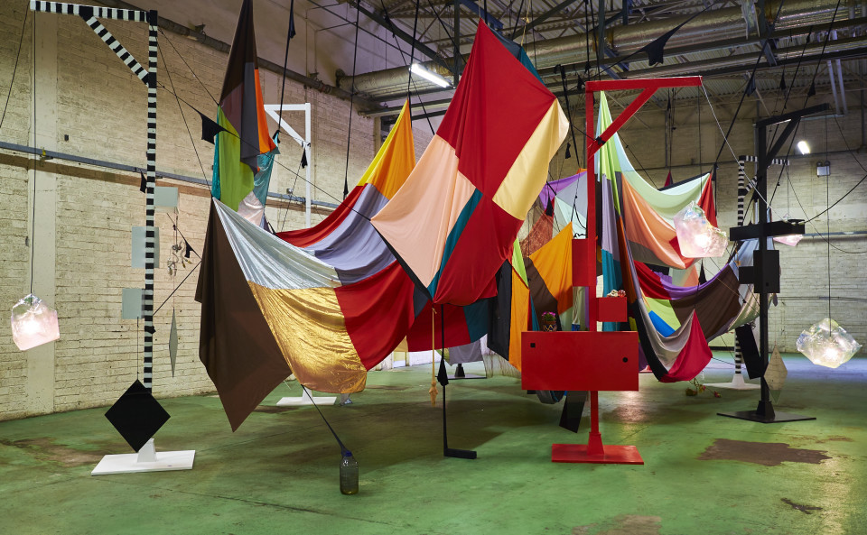 installation view; Mikala Dwyer Square Cloud Compound, 2010; fabric, stockings, pins, glass bottles, rocks, lights and lamps; Dimensions variable. Adjustable height; enquire