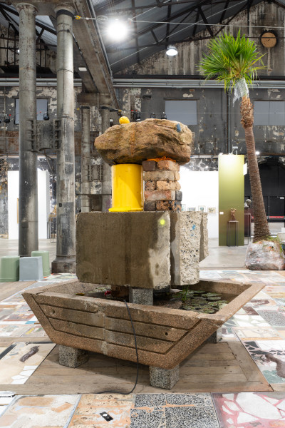 Mike Hewson Frog pond fountain stack, 2026; salvaged Sydney Opera House precast concrete panels, concrete ballast masonry unit, Sydney Sandstock brick, Mount Gambier sandstone blocks, custom-moulded plastic bucket, salvaged Sydney sandstone, granite, recirculating pond pump; 200 x 170 x 120 cm; enquire