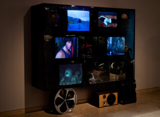 TV Moore Cabinet of ideas and future visions (cash converters), 2009; Wood, reflective paint, Mirrors, Internal Lights, Unique Objects, Ceramics, car rimm, speakers, Perspex, blind girl portrait of artist , clay, glaze, CTR Monitors.
7 Individual DVD works:; RAMBO RAMBO RAMBO<br> CASH BACK<br> ET & THE END OF A DREAM<br>EXISTENCE PLEASE<br>HOLY SMOKES<br>THE SWIMMER<br>HYPNO HYPO<br>dimensions variable; Enquire