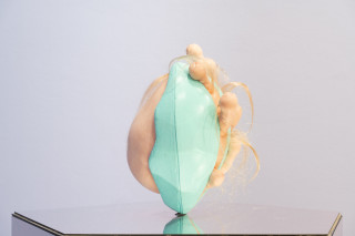 Patricia Piccinini Egg Head in Motion, 2025; silicone, polyurethane, hair, stainless steel, microcontroller, motor, mirrored plinth; 95 x 50 x 61 cm; From a suite of 3 colour variations; enquire